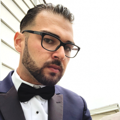 A person wearing glasses and a suit and tie
